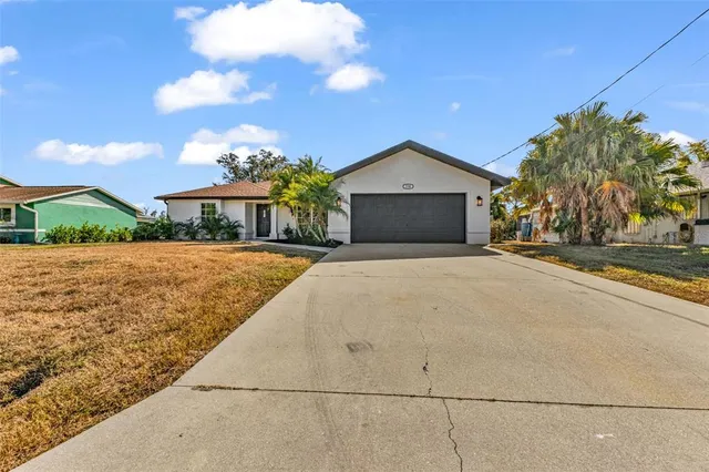 an aerial view of a house with yard