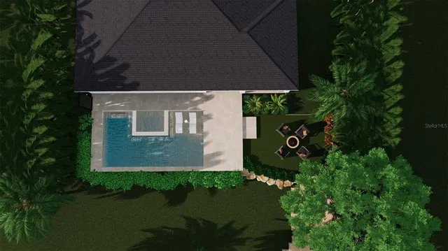 a view of a chairs and table in patio next to a yard