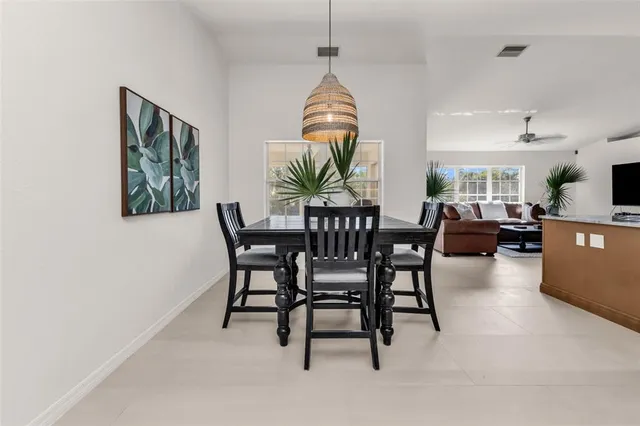 a view of a dining room with furniture and a kitchen