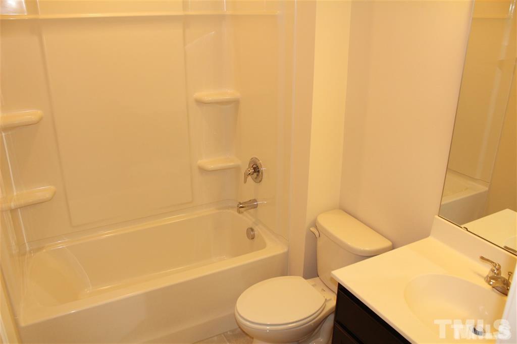 2102 Peakside Drive Apex, NC 27523 - Photo 15 of 21 a bathroom with a sink a toilet and bathtub
