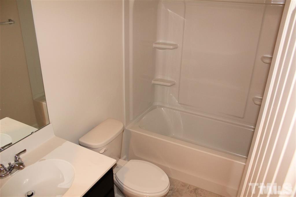 2102 Peakside Drive Apex, NC 27523 - Photo 17 of 21 a bathroom with a sink and a toilet