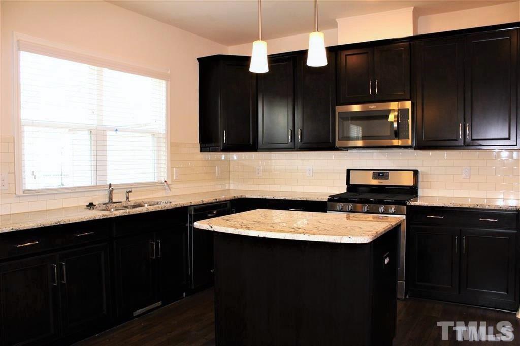 2102 Peakside Drive Apex, NC 27523 - Photo 2 of 21 a kitchen with a sink stove and microwave