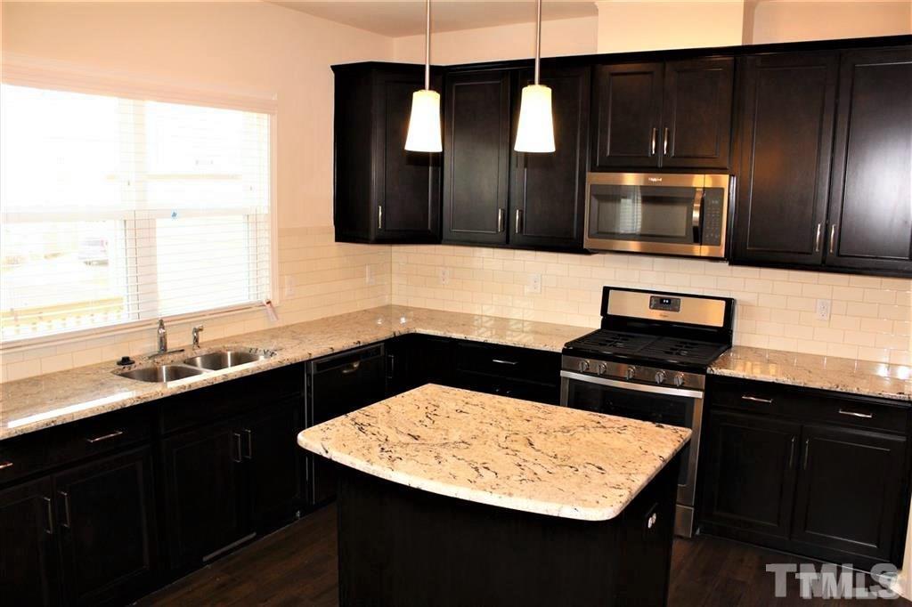 2102 Peakside Drive Apex, NC 27523 - Photo 3 of 21 a kitchen with a sink and a microwave