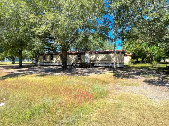 a house view with swimming pool in front of it