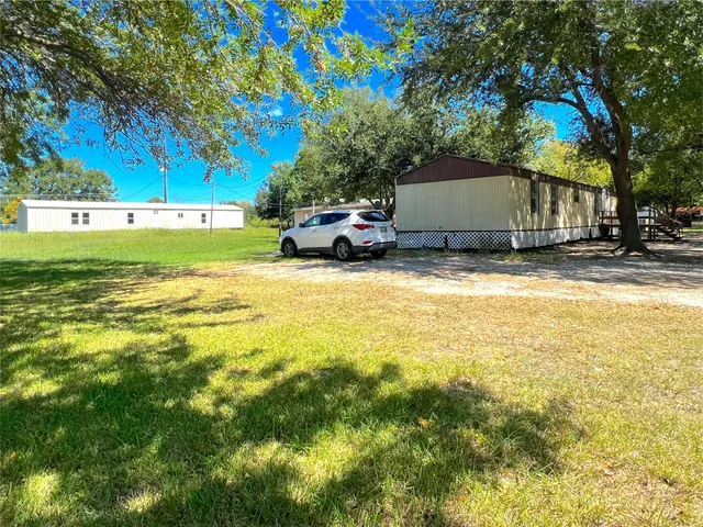a house view with a sitting space and garden space