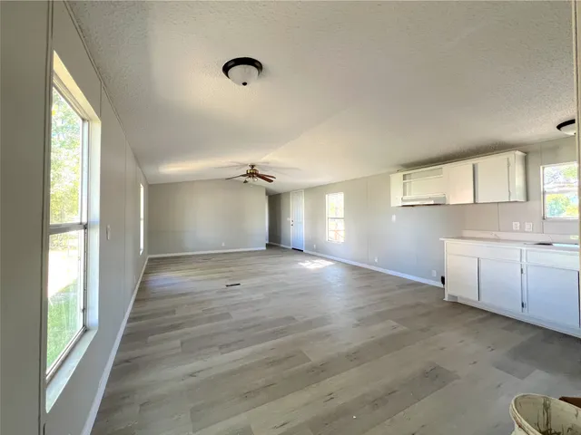 a view of a kitchen with a sink and dishwasher cabinets