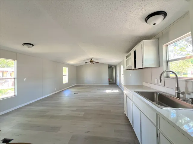 a kitchen with a sink cabinets and window