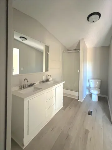 a spacious bathroom with a double vanity sink and a mirror