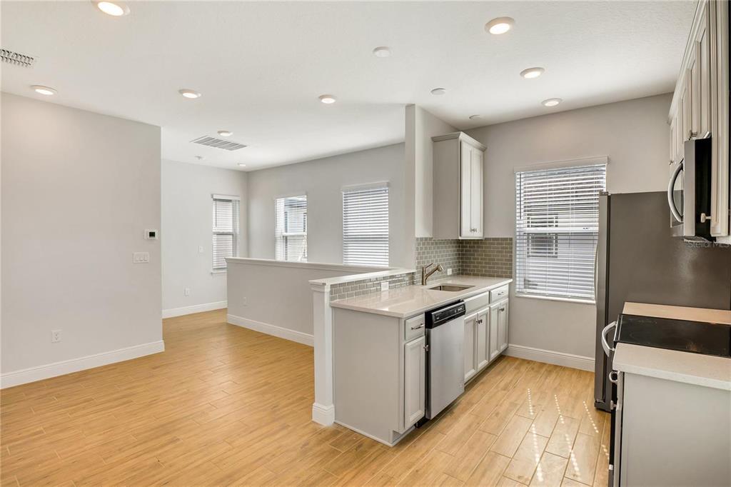 6547 Rover Way St. Cloud, FL 34771 - Photo 4 of 11 a kitchen with a sink stove and refrigerator