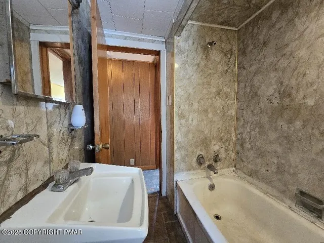 an empty room with wooden floor and closet