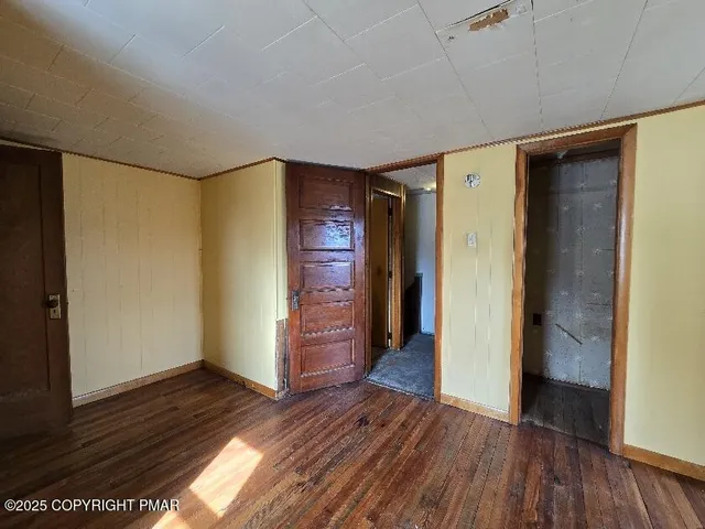 a view of hallway with wooden floor