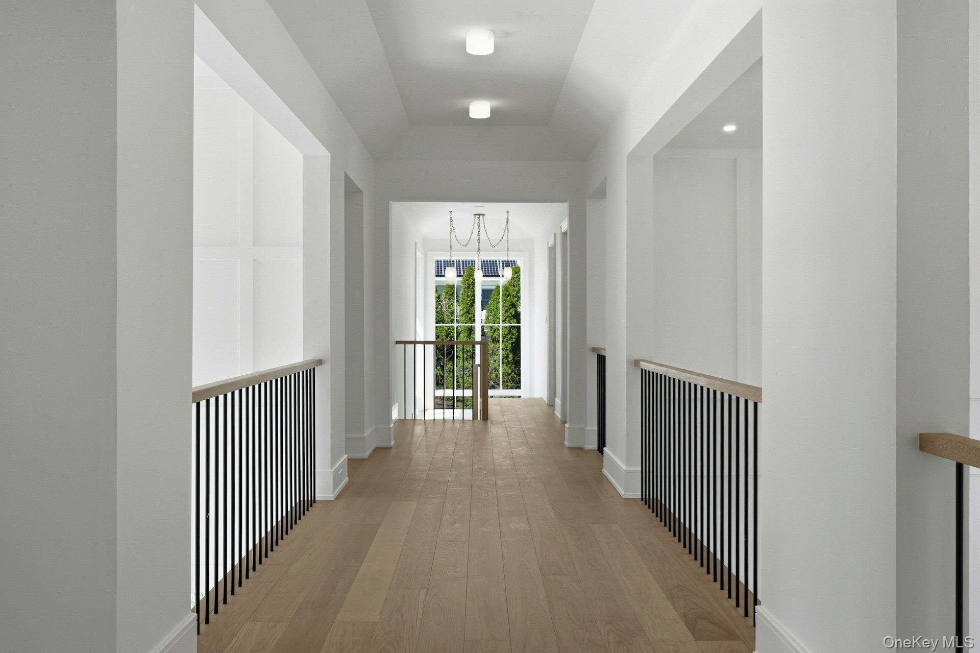 25 West Creek Farms Road Sands Point, NY 11050 - Photo 23 of 39 a view of a hallway with wooden floor and windows