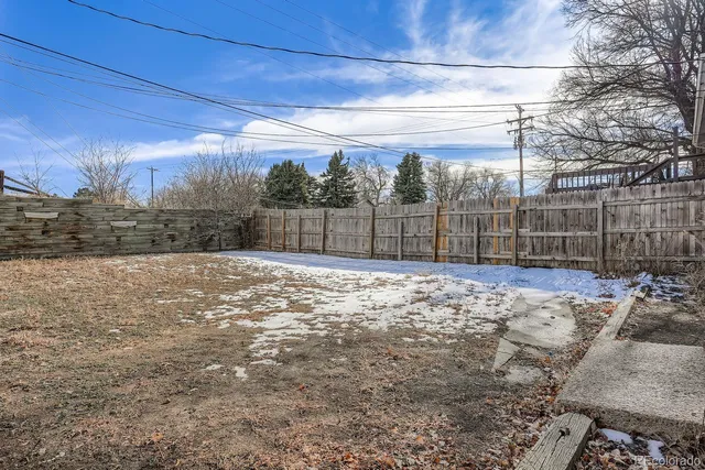 a view of a house with a wooden deck and a backyard