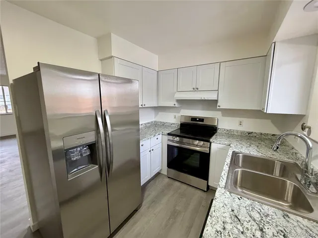 a kitchen with a refrigerator sink and stove
