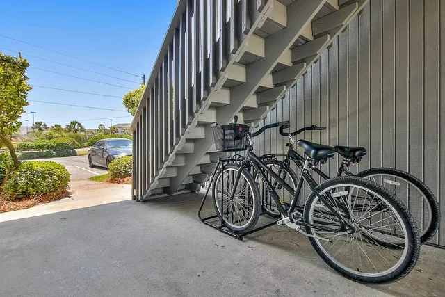 a view of a swimming pool with a lounge chairs in front of a house