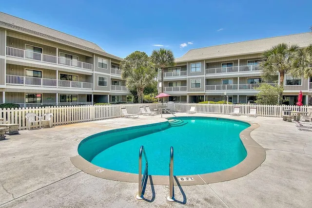 a view of a swimming pool with a yard