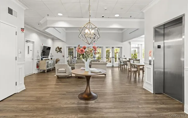 a living room with couches and chandelier