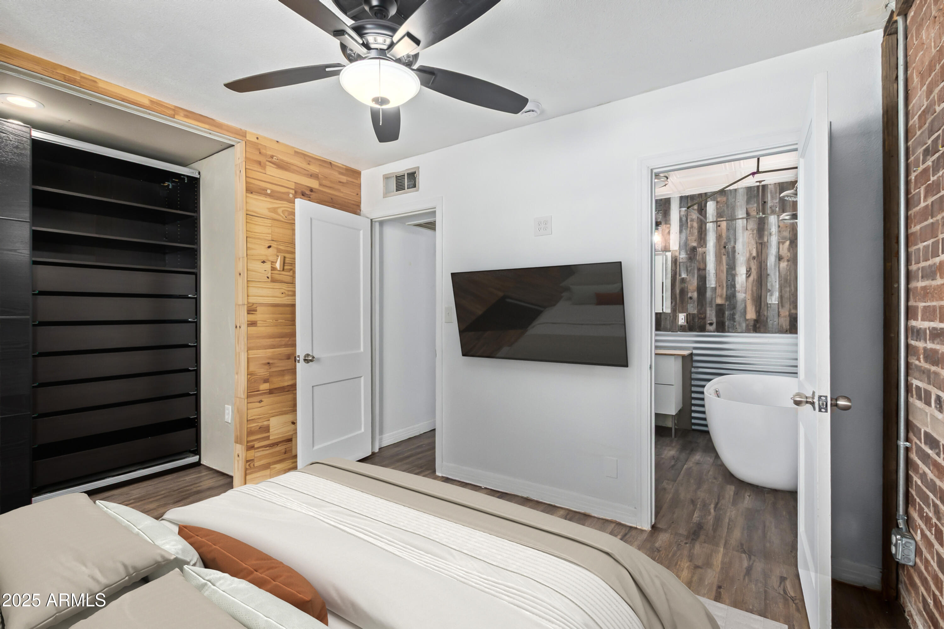 2615 North 29th Place Phoenix, AZ 85008 - Photo 11 of 26 a bedroom with a bed and a television