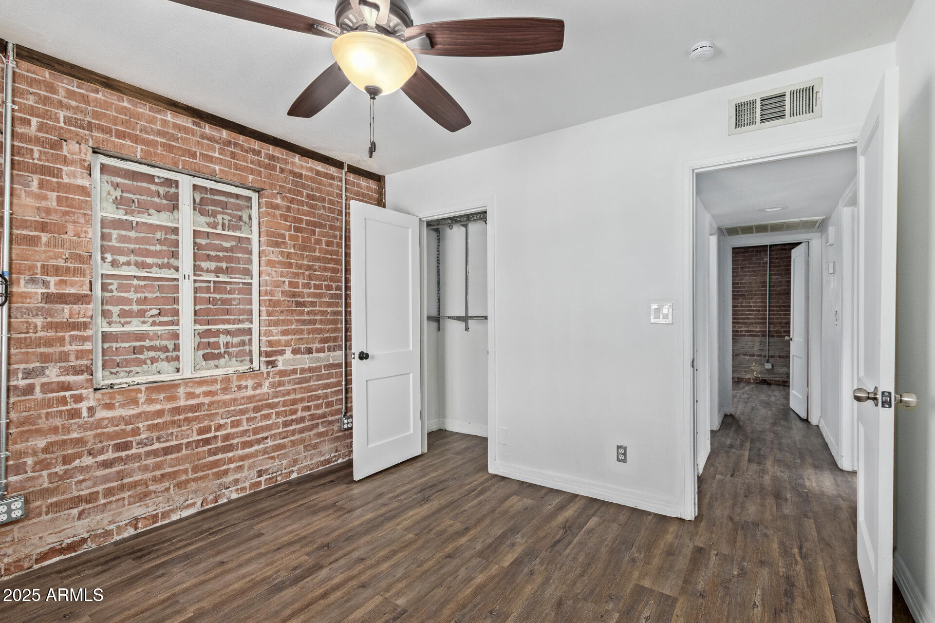 2615 North 29th Place Phoenix, AZ 85008 - Photo 14 of 26 a view of an empty room with wooden floor and a window