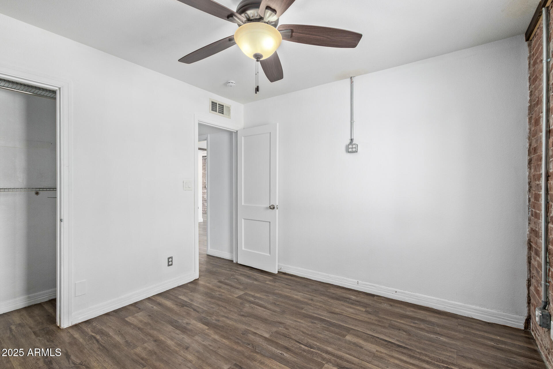 2615 North 29th Place Phoenix, AZ 85008 - Photo 15 of 26 a view of a room with wooden floor and a ceiling fan