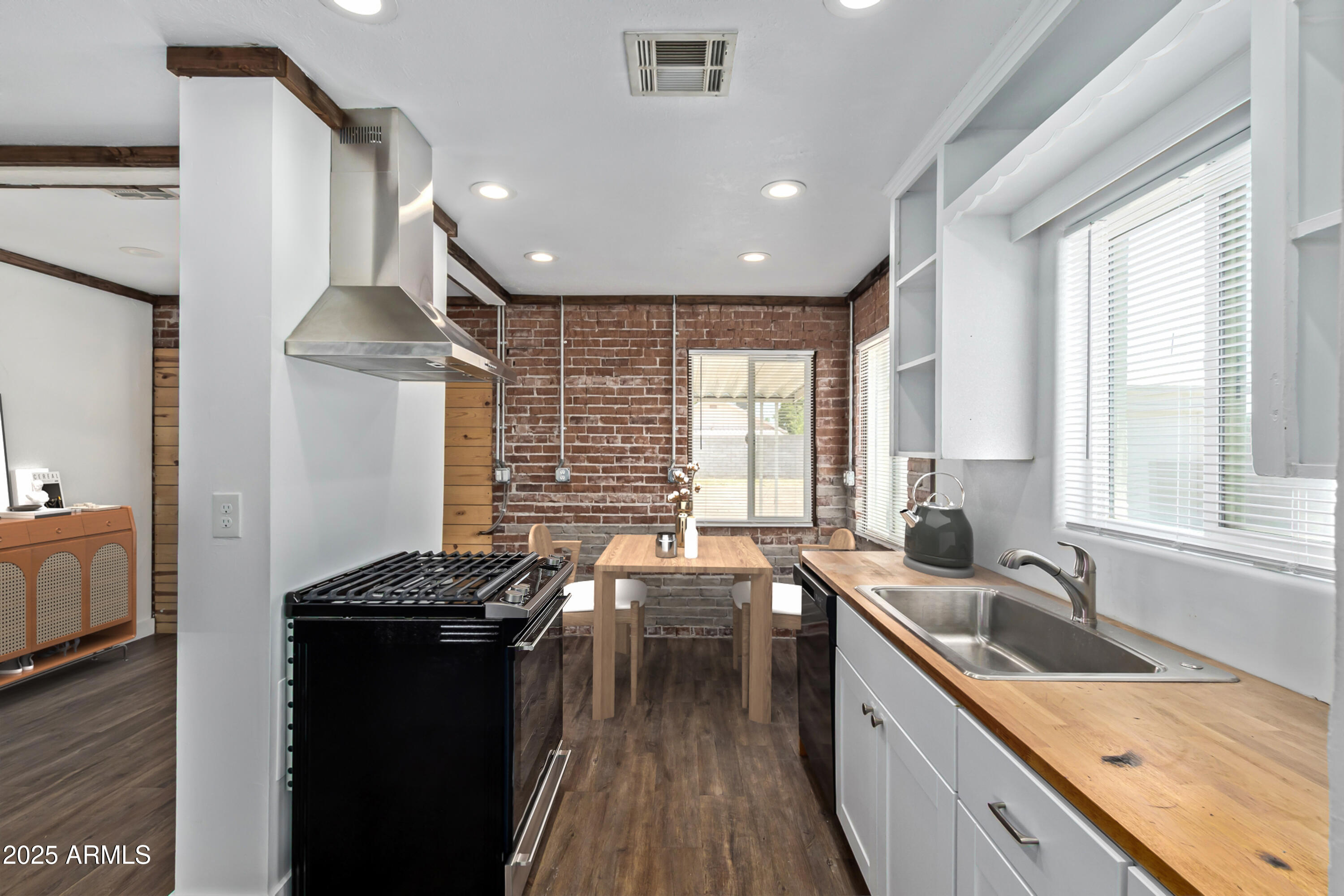 2615 North 29th Place Phoenix, AZ 85008 - Photo 7 of 26 a kitchen with granite countertop a sink stove and cabinets