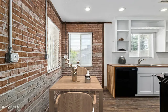 a large kitchen with kitchen island granite countertop a large window and a counter space