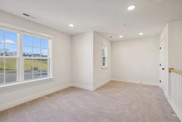 an empty room with windows and closet