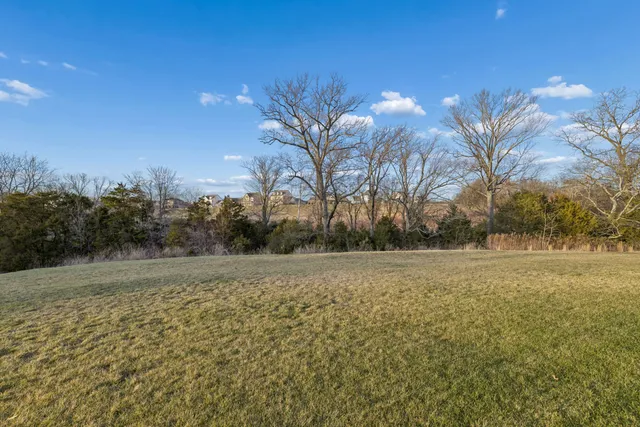 a view of a balcony with flower plants and wooden fence