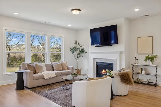 a living room with furniture fireplace and flat screen tv