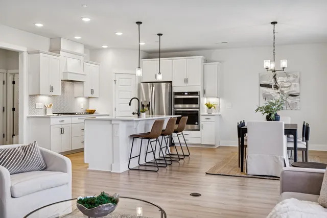 a living room with kitchen island furniture and a kitchen view