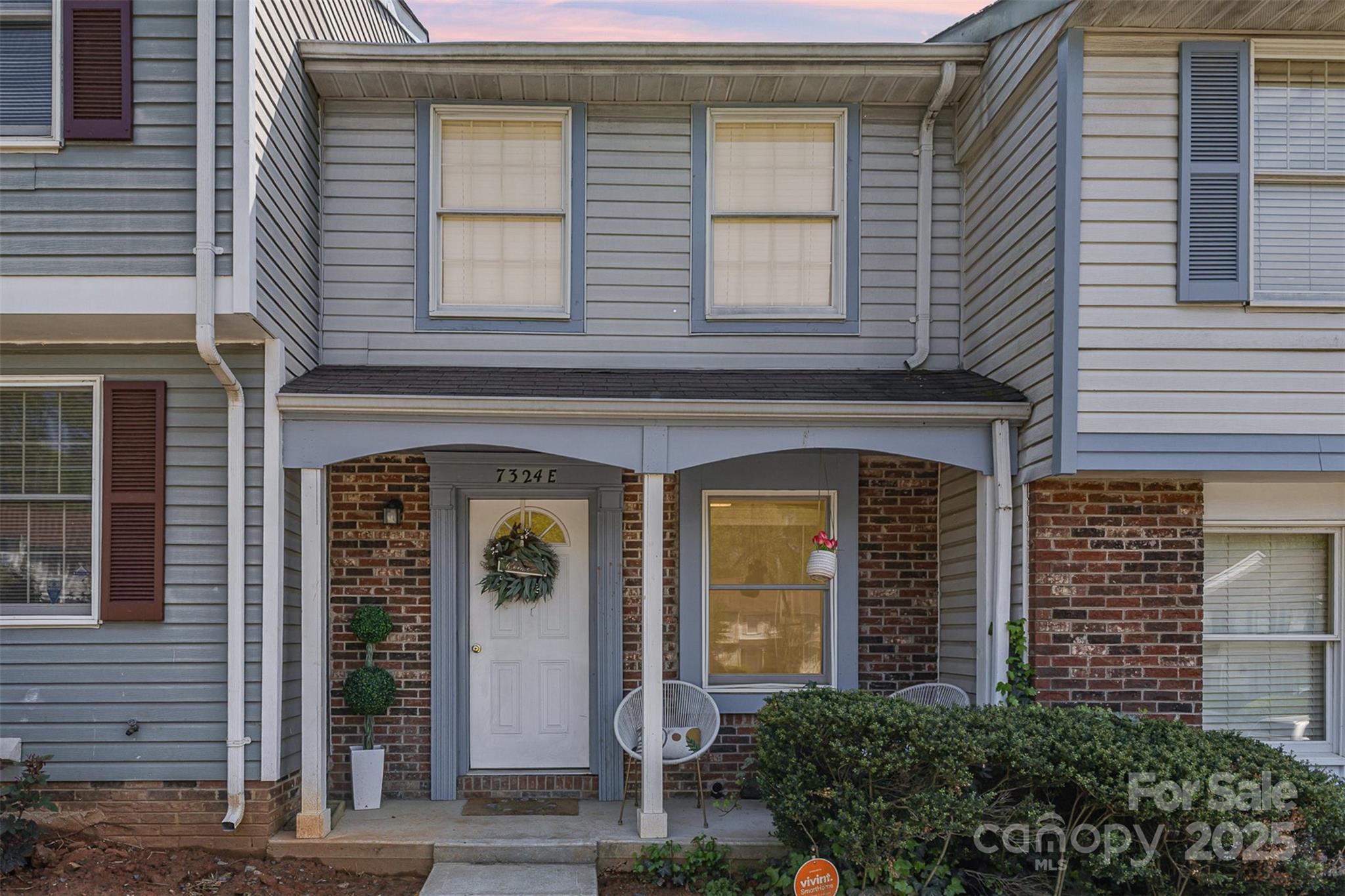front view of a brick house with a large windows