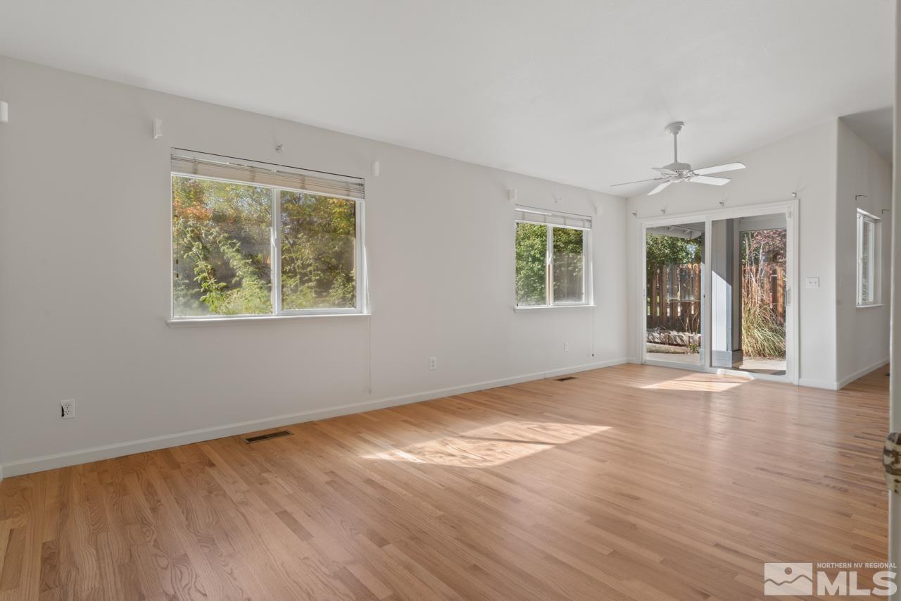 17040 Castle Pine Drive Reno, NV 89511 - Photo 13 of 31 a view of an empty room with wooden floor and a window