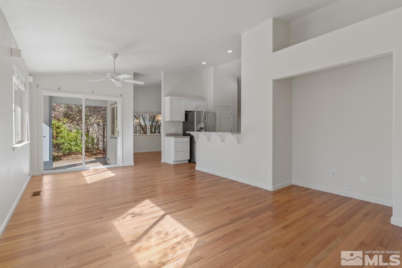 17040 Castle Pine Drive Reno, NV 89511 - Photo 14 of 31 a view of empty room with wooden floor and windows