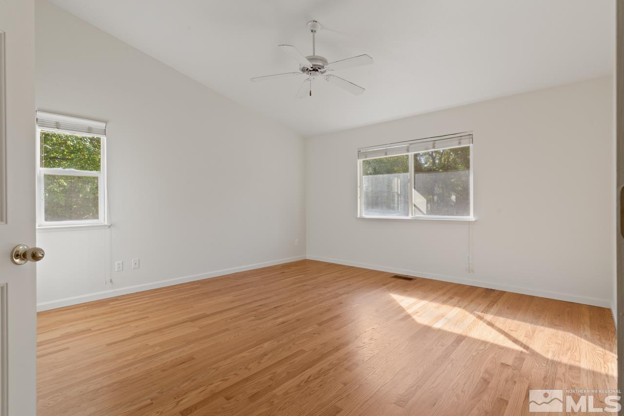 17040 Castle Pine Drive Reno, NV 89511 - Photo 16 of 31 a view of an empty room with wooden floor and a window