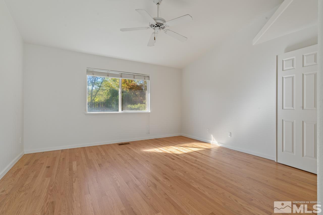 17040 Castle Pine Drive Reno, NV 89511 - Photo 18 of 31 wooden floor in an empty room with a window