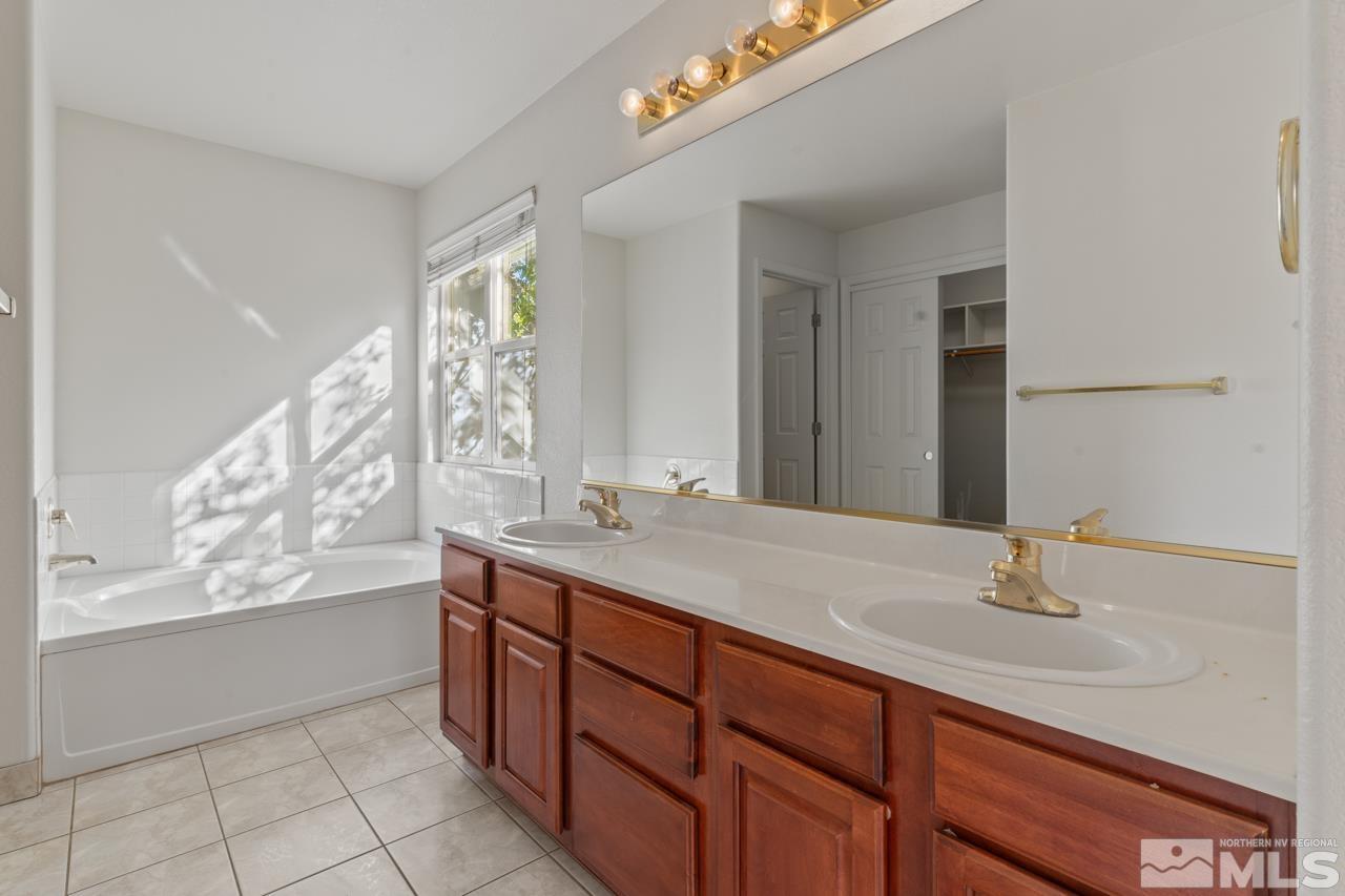 17040 Castle Pine Drive Reno, NV 89511 - Photo 19 of 31 a bathroom with a sink and a mirror