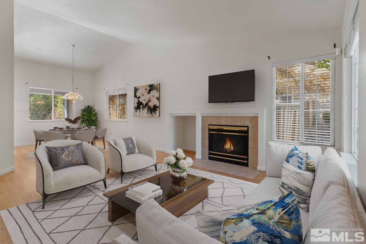 17040 Castle Pine Drive Reno, NV 89511 - Photo 4 of 31 a living room with furniture a flat screen tv and a fireplace