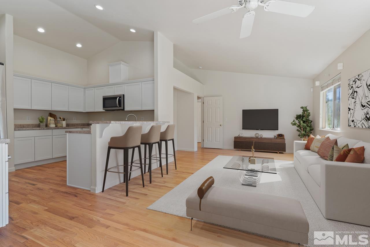 17040 Castle Pine Drive Reno, NV 89511 - Photo 8 of 31 a living room with furniture a flat screen tv and kitchen view