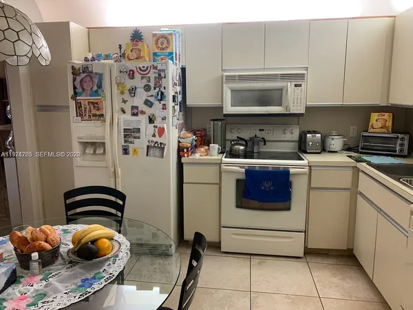 a kitchen with a sink a stove and cabinets