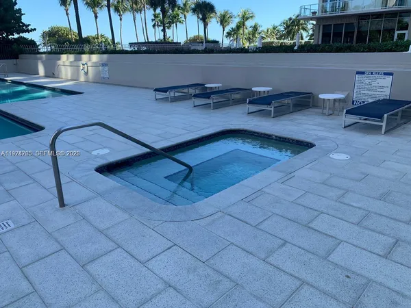 a view of swimming pool with outdoor seating and plants