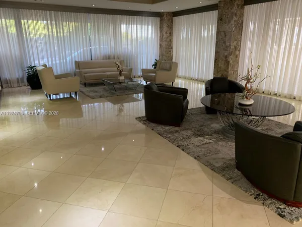 a living room with furniture and large windows