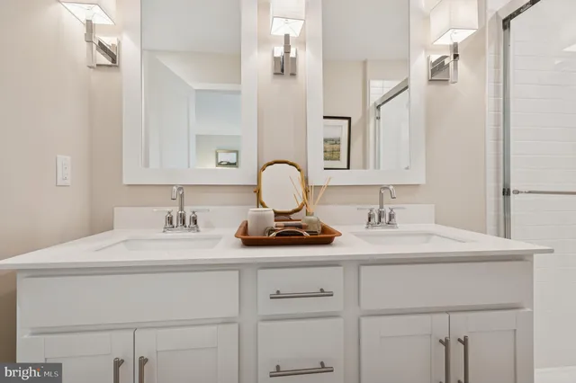 a bathroom with a sink vanity granite and a mirror