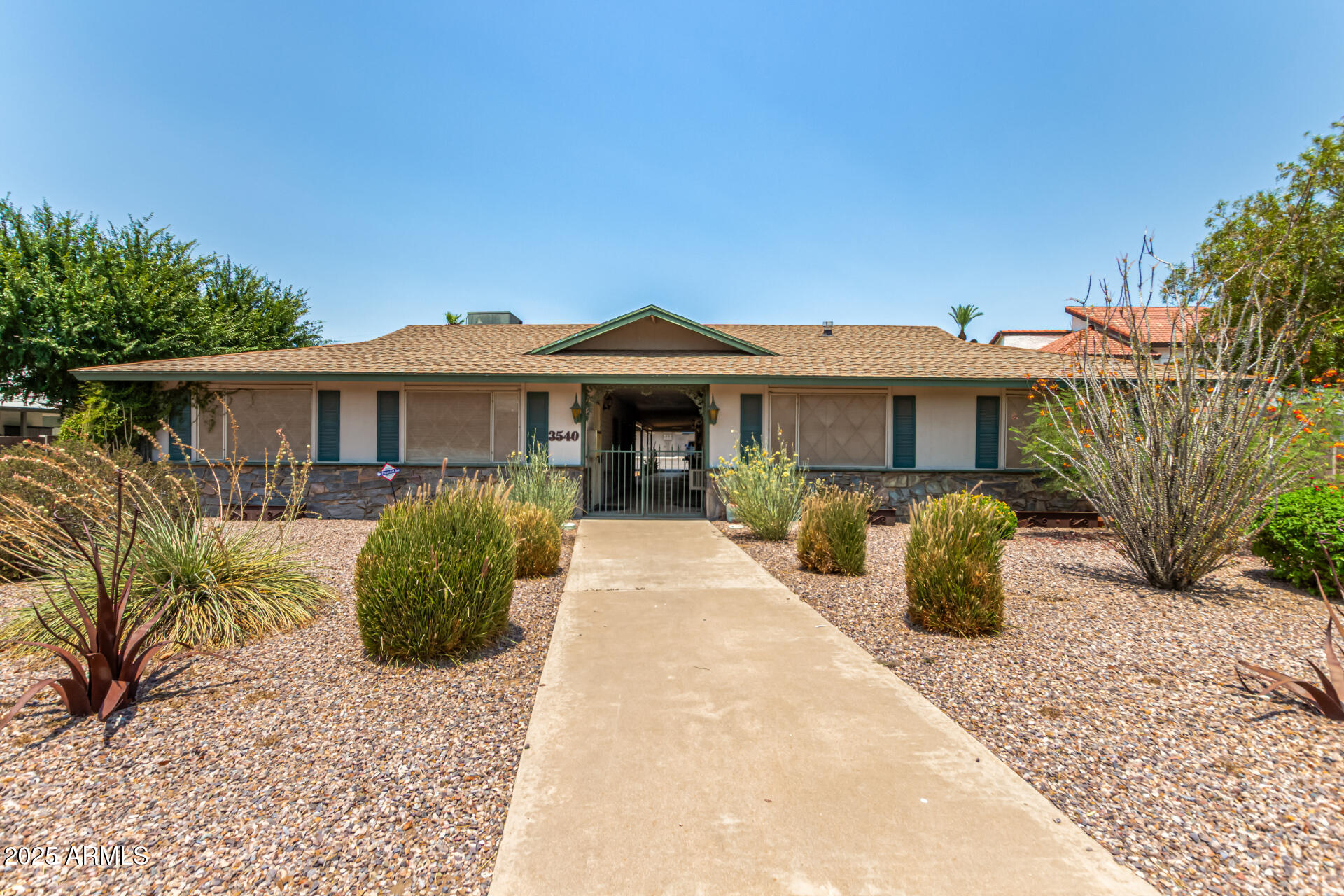 3540 East Montecito Avenue, Unit 1 Phoenix, AZ 85018 - Photo 1 of 26 a front view of a house with a garden