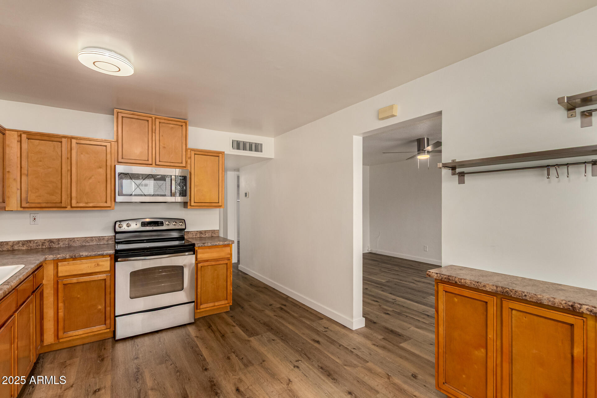 3540 East Montecito Avenue, Unit 1 Phoenix, AZ 85018 - Photo 14 of 26 a kitchen with wooden floors and stainless steel appliances