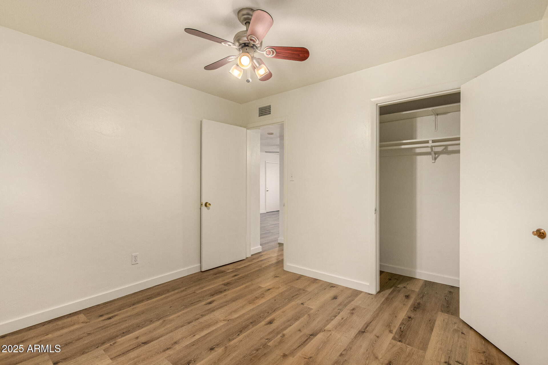 3540 East Montecito Avenue, Unit 1 Phoenix, AZ 85018 - Photo 16 of 26 a view of an empty room with wooden floor