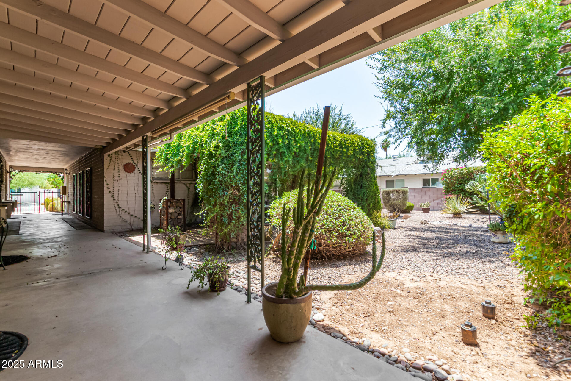 3540 East Montecito Avenue, Unit 1 Phoenix, AZ 85018 - Photo 23 of 26 a view of a patio with a table and chairs next to a yard