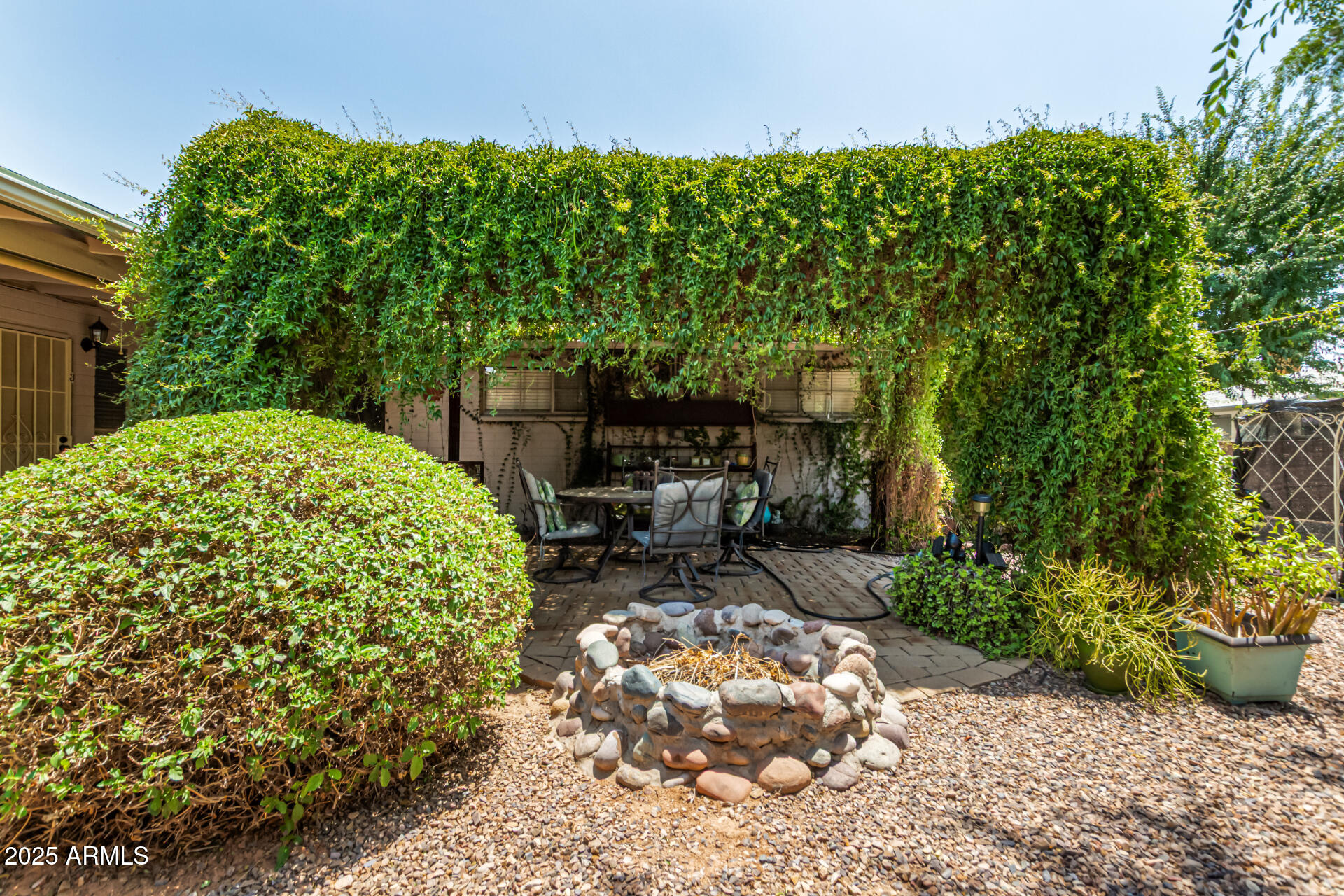 3540 East Montecito Avenue, Unit 1 Phoenix, AZ 85018 - Photo 24 of 26 a garden with a bench in the garden