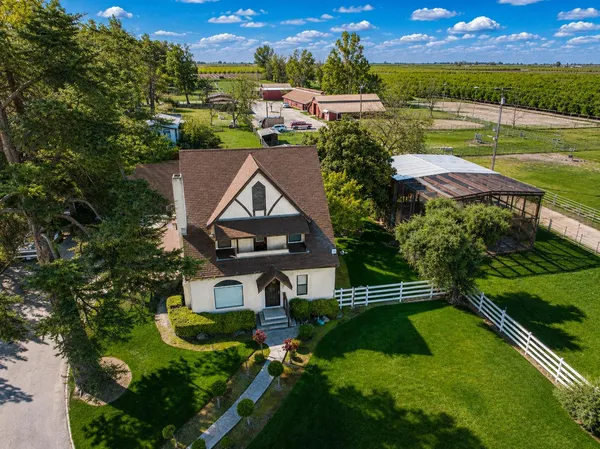 an aerial view of a house with garden space lake view and mountain view in back
