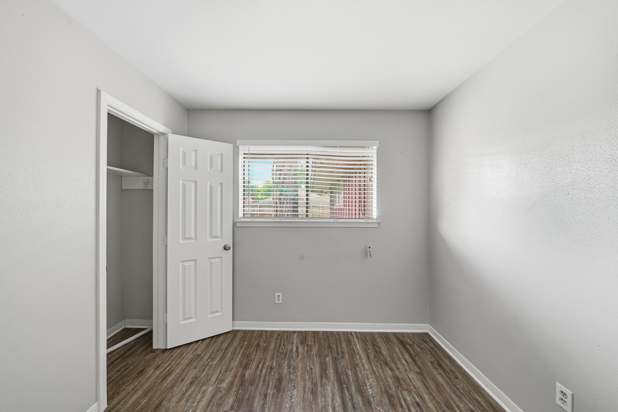 6410 Hopper Road Houston, TX 77016 - Photo 16 of 28 a view of a room with wooden floor and windows