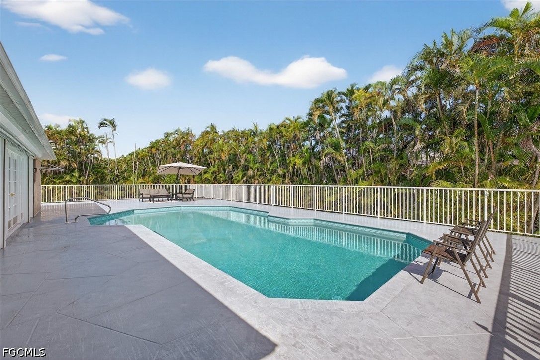 13570 Harbour Ridge Drive Fort Myers, FL 33908 - Photo 41 of 50 a view of a swimming pool with a lawn chairs